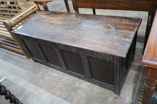 An 18th century and later carved panelled oak coffer, width 145cm, depth 58cm, height 61cm